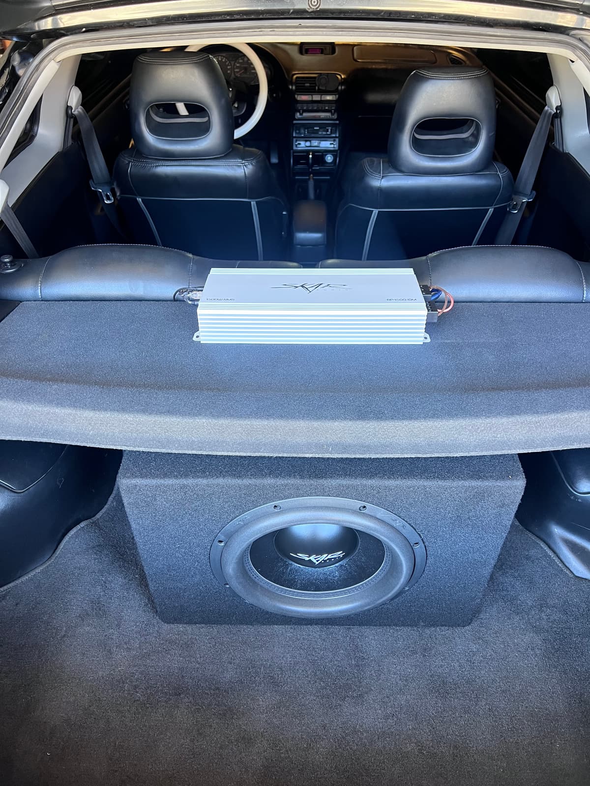 The Integra's hatch audio install: amplifier on the rear deck and the subwoofer enclosure below
