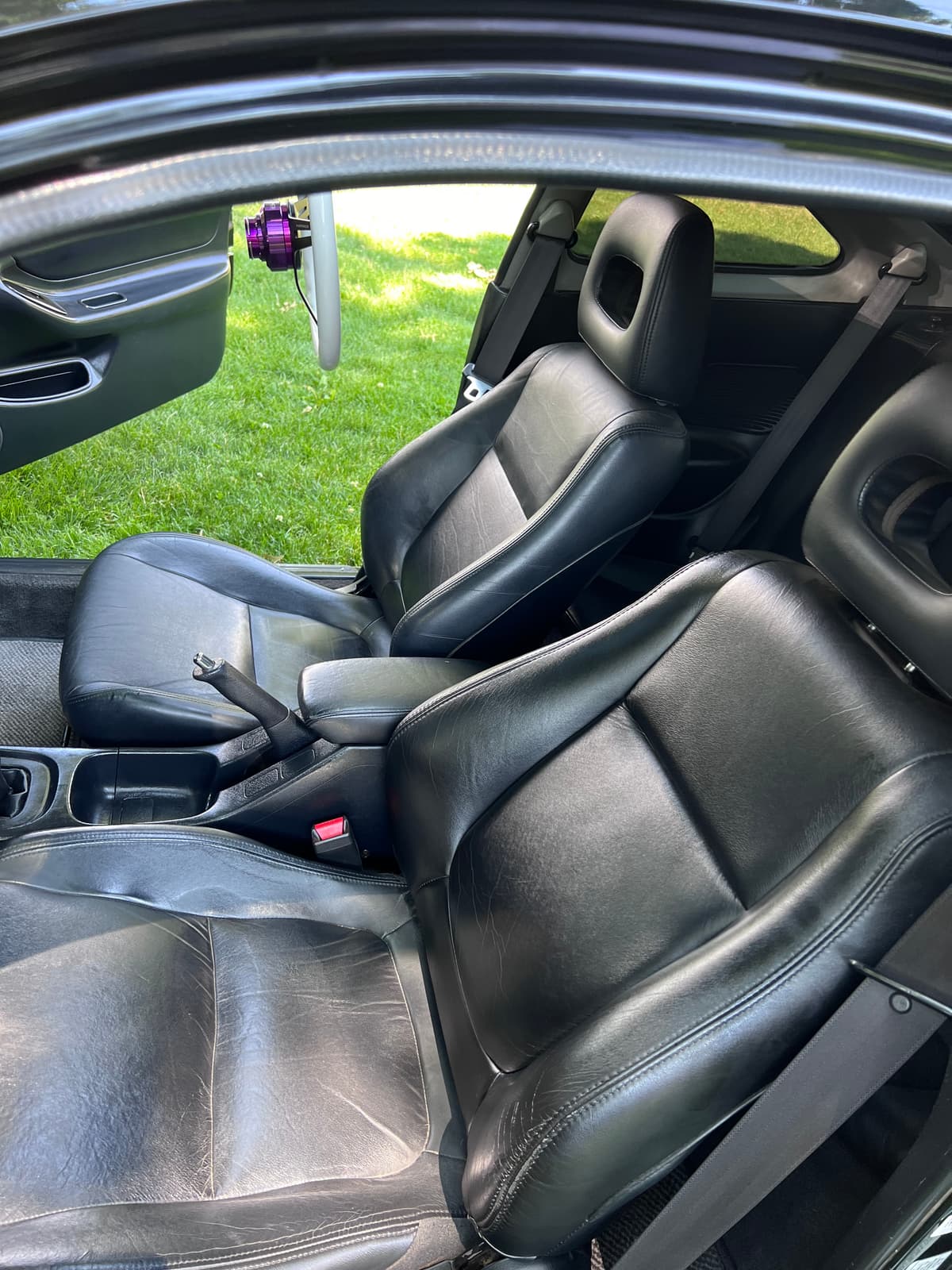 Black leather front seats in the Integra GSR seen through the open door