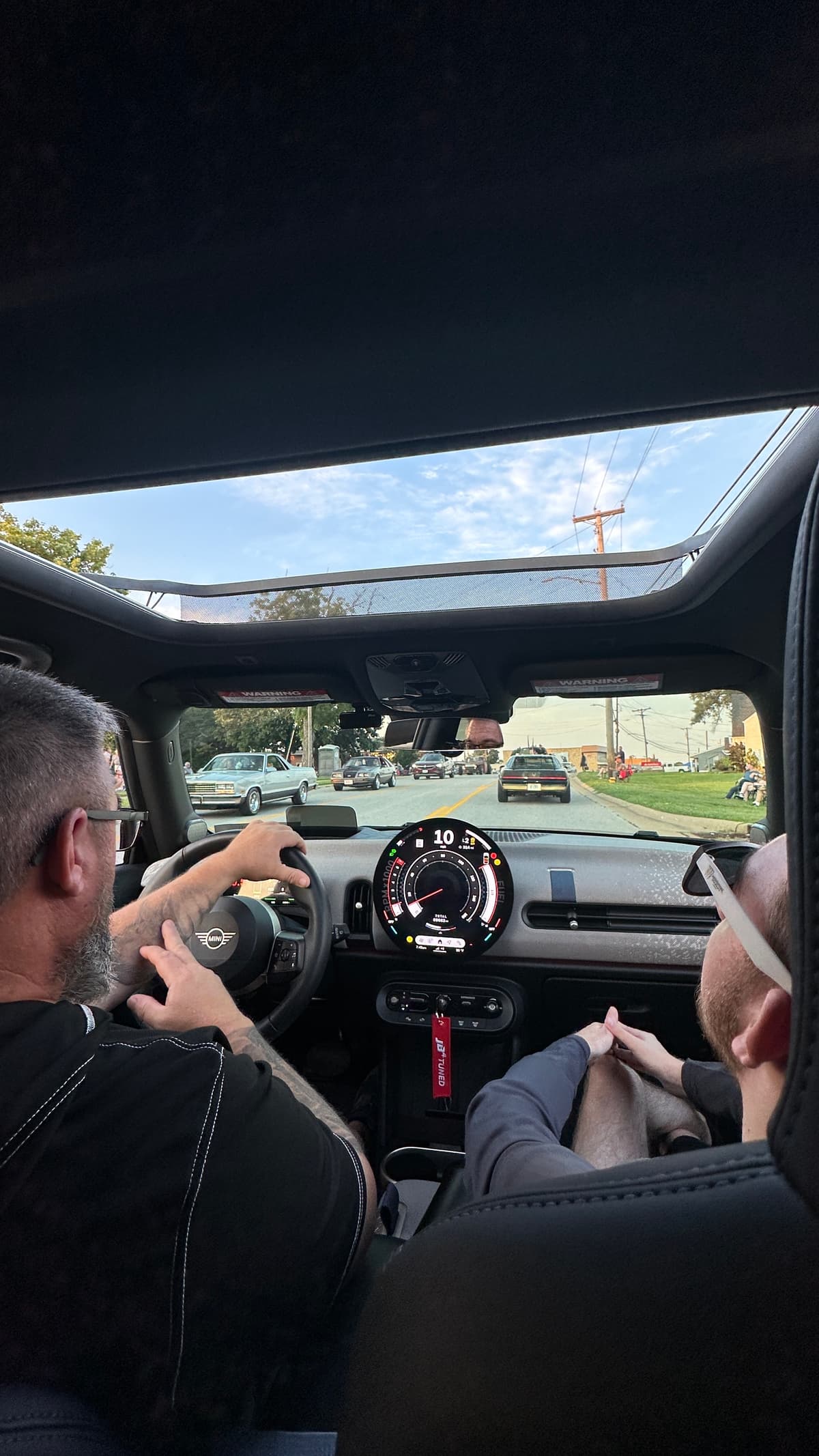 View from the rear seat of Steve driving with his son in the passenger seat
